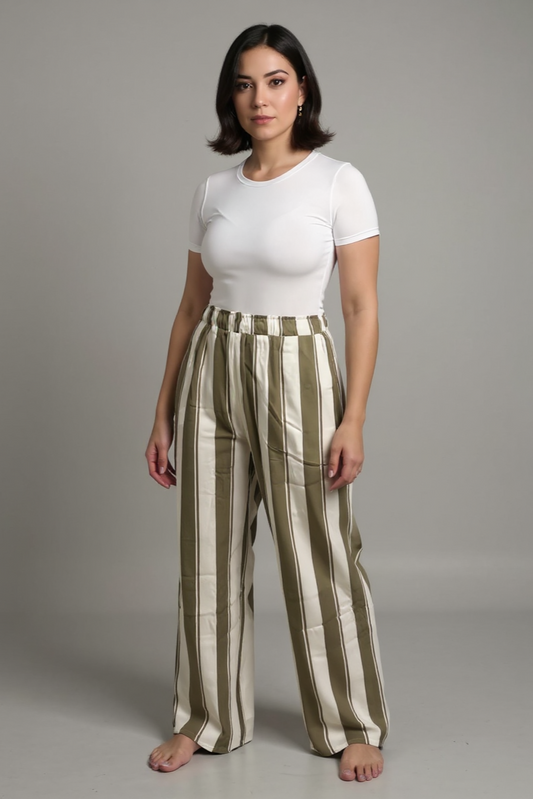 Woman wearing a white top and striped pants on a gray background